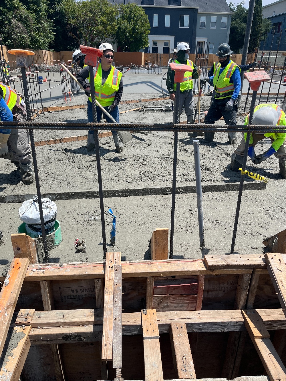 workers pouring concrete at construction project in San Jose