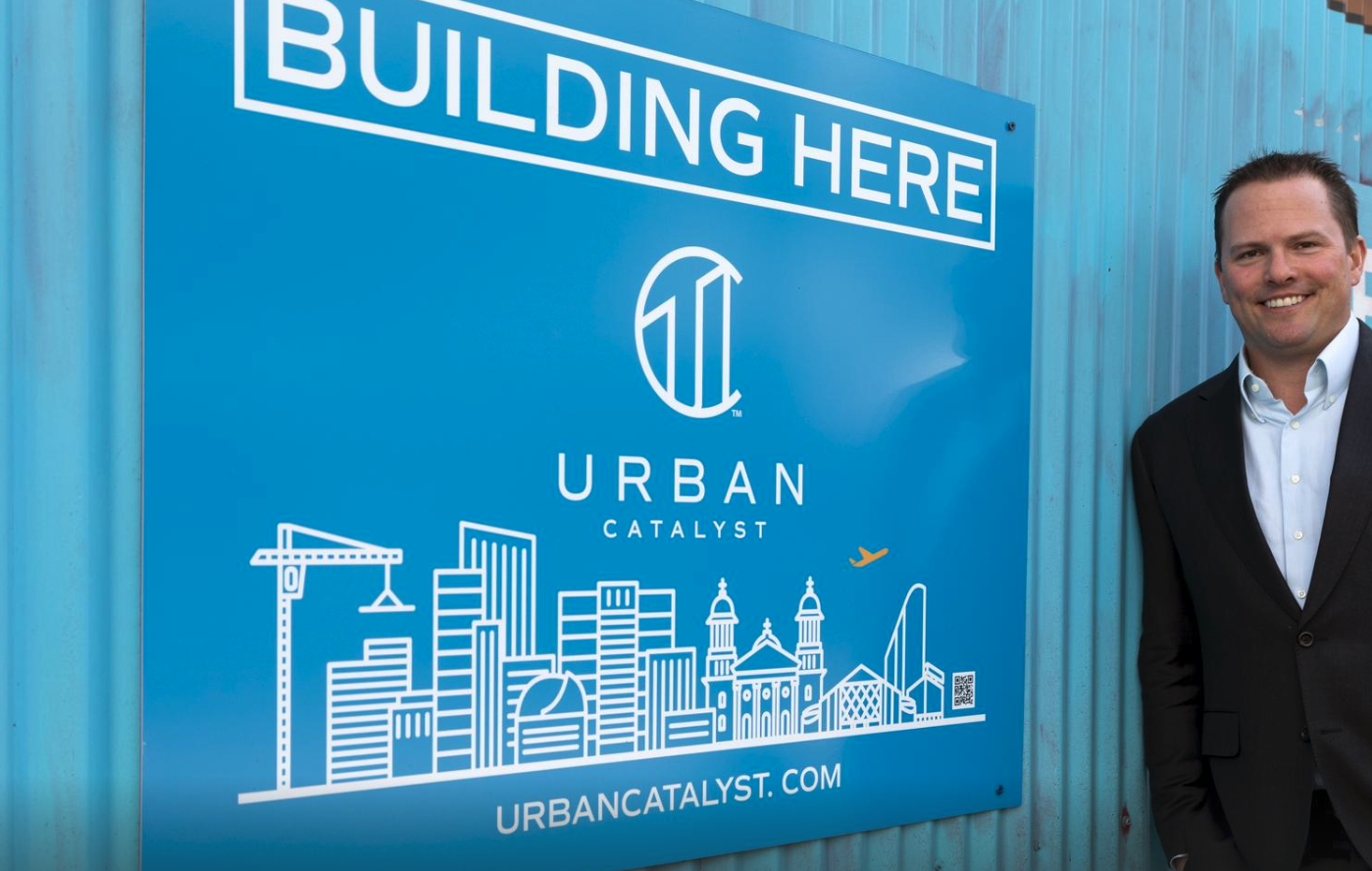 Erik Hayden in front of Urban Catalyst sign