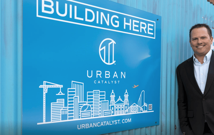 Erik Hayden iin front of Urban Catalyst signage